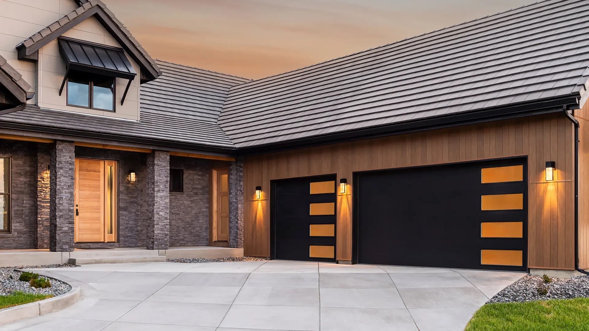 Modern black aluminum and glass garage door installed by Valor Garage Door Service